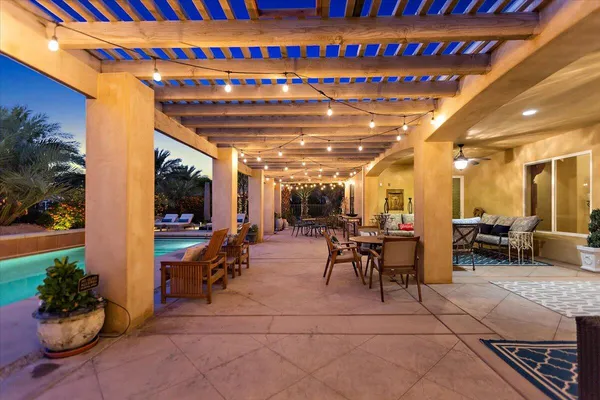 a swimming pool with outdoor seating and yard