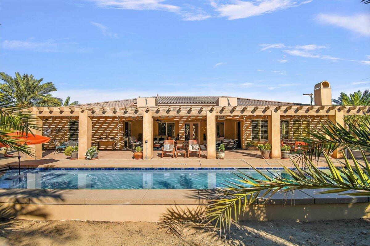 31453 Chimayo Road Thousand Palms, CA 92276 - Photo 56 of 71 a view of a swimming pool with an outdoor seating