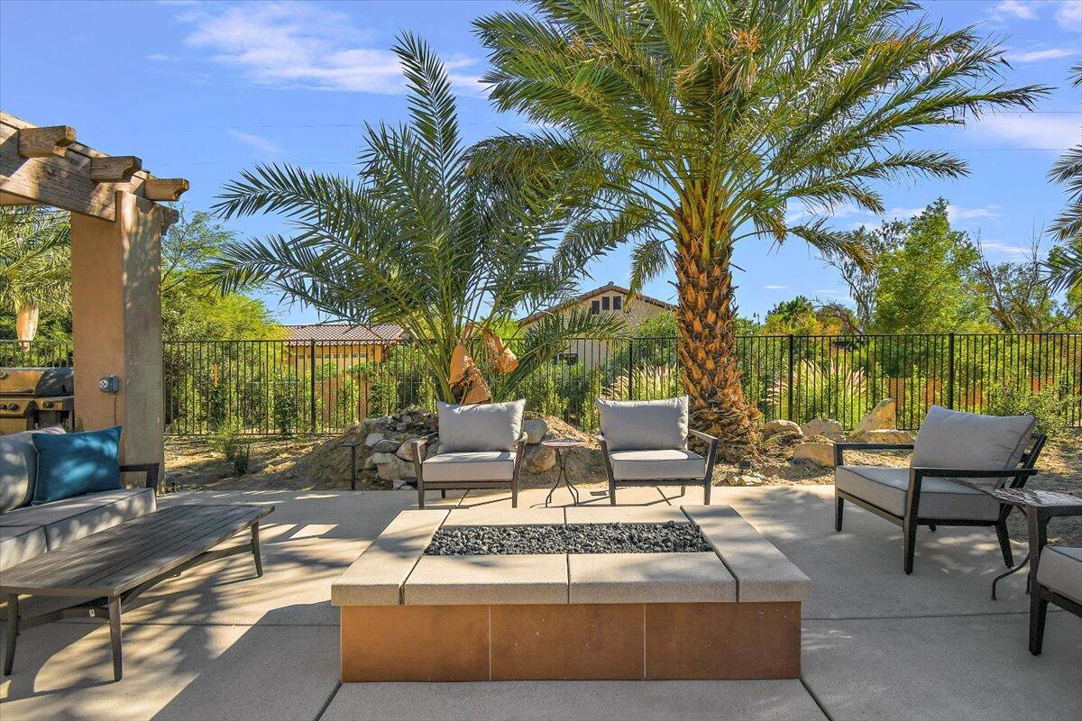 31453 Chimayo Road Thousand Palms, CA 92276 - Photo 62 of 71 a view of a patio with couches and a fire pit and large trees