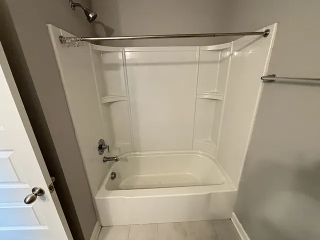 an empty room with closet and a ceiling fan