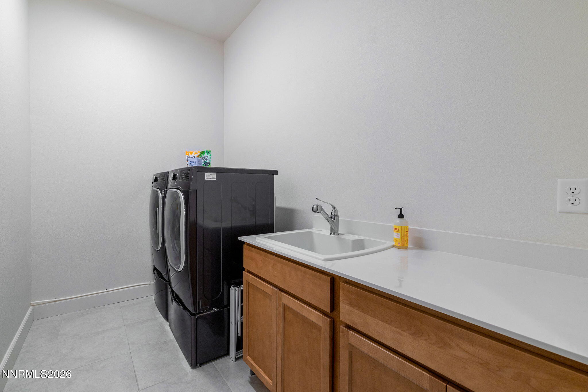 9505 Copper Sky Drive Reno, NV 89521 - Photo 29 of 50 a utility room with cabinets and washer dryer