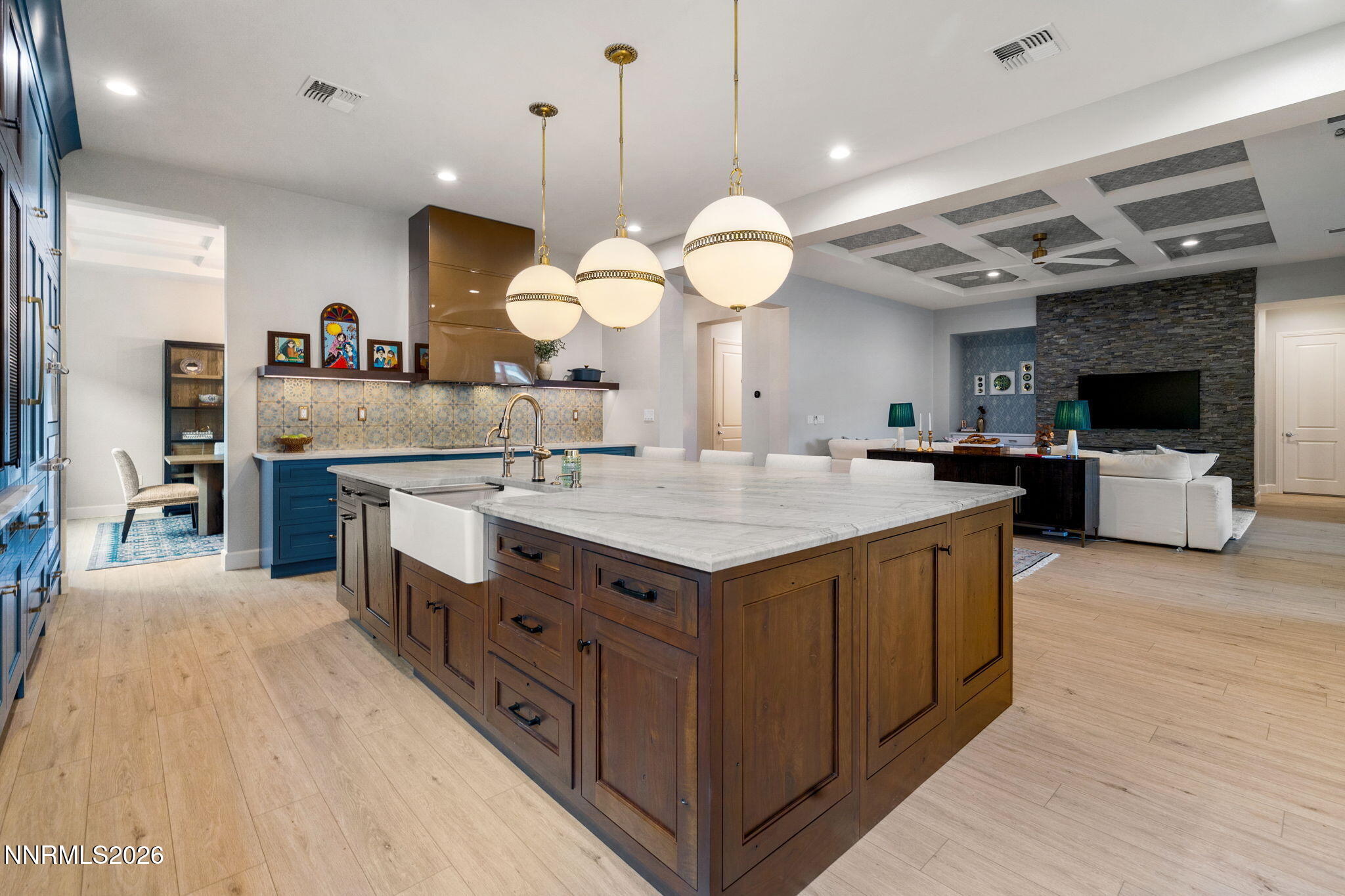 9505 Copper Sky Drive Reno, NV 89521 - Photo 3 of 50 a large kitchen with stainless steel appliances a stove center island a fireplace and a flat screen tv