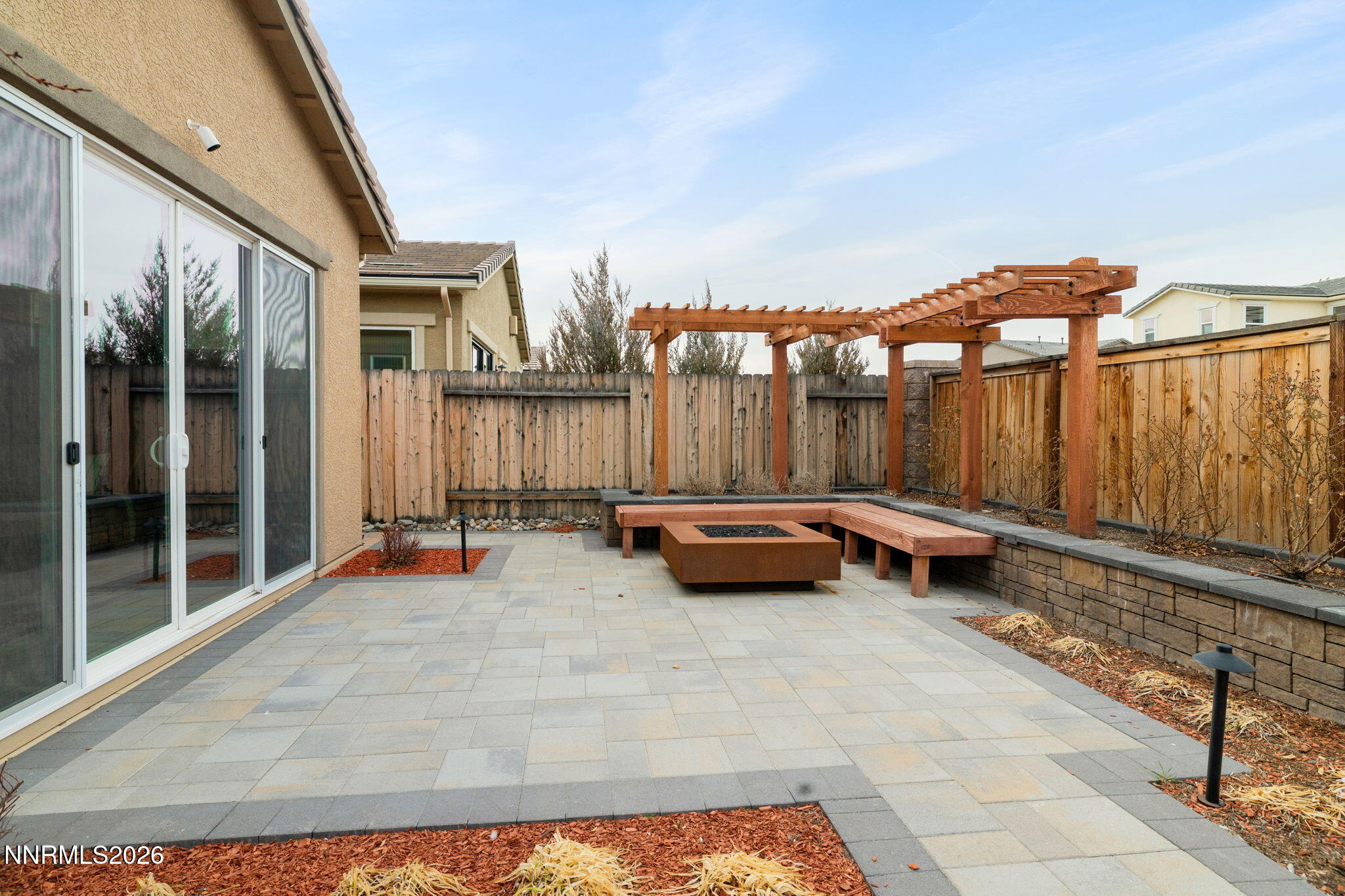 9505 Copper Sky Drive Reno, NV 89521 - Photo 39 of 50 a backyard of a house with barbeque oven table and chairs