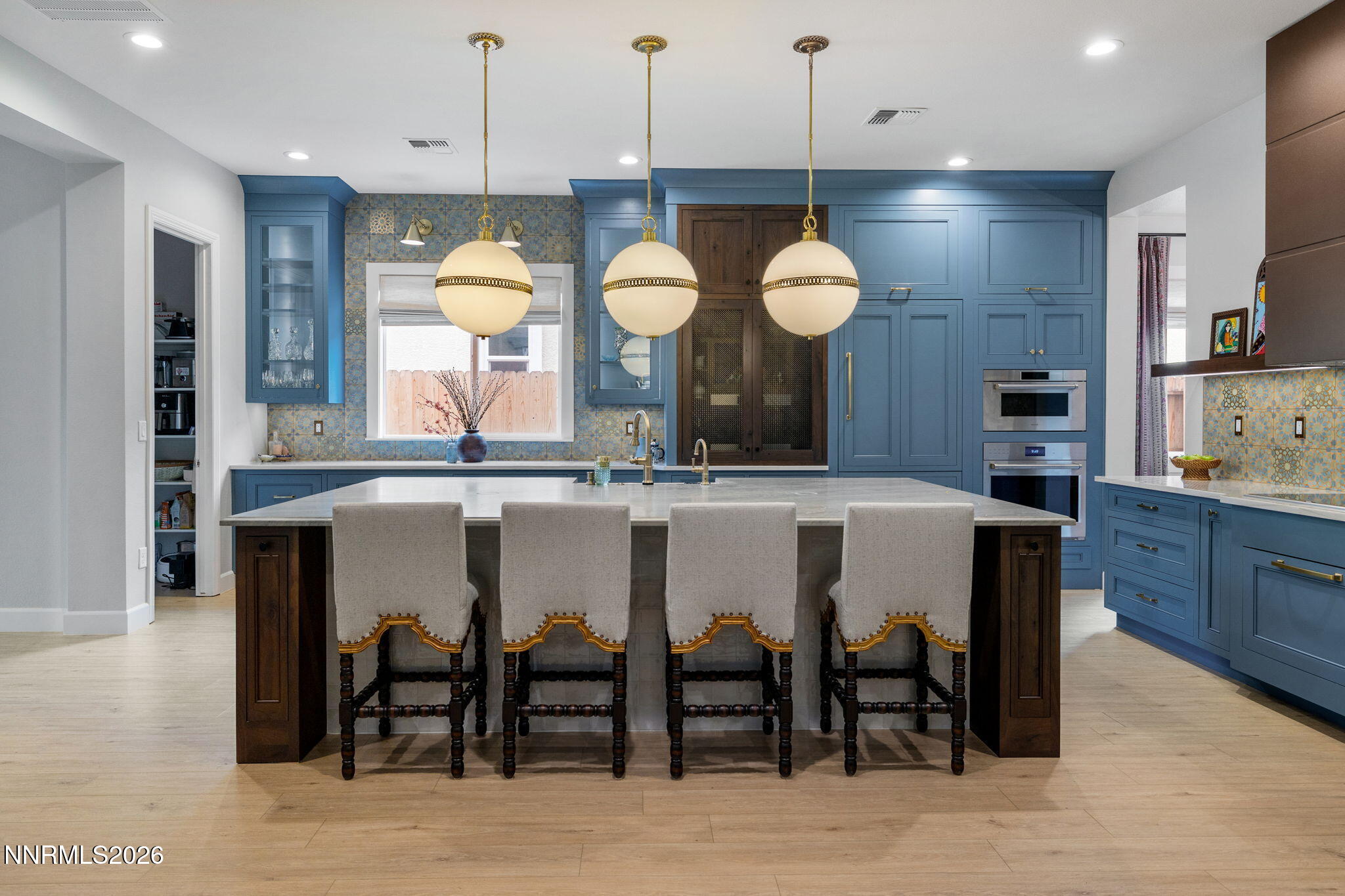 9505 Copper Sky Drive Reno, NV 89521 - Photo 4 of 50 a kitchen with a dining table cabinets and stainless steel appliances