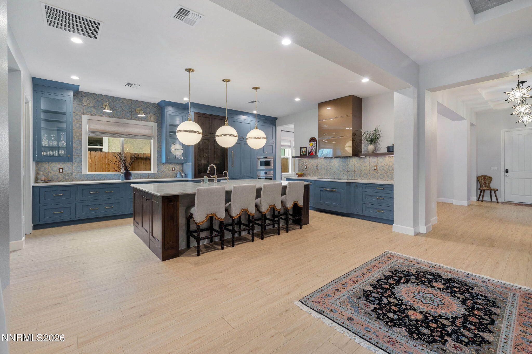 9505 Copper Sky Drive Reno, NV 89521 - Photo 5 of 50 a large kitchen with a large counter top and stainless steel appliances