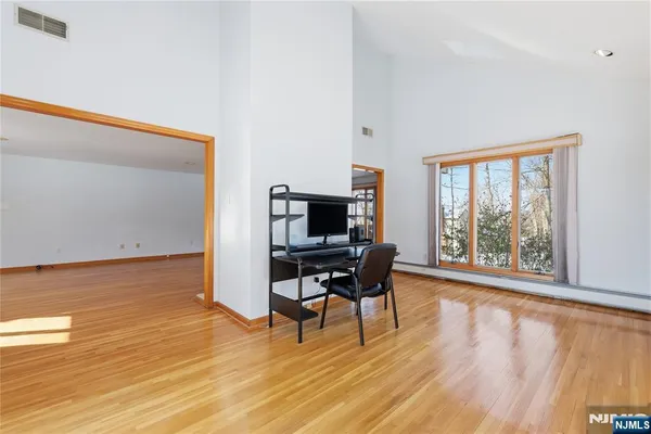 a kitchen with a sink cabinets and wooden floor