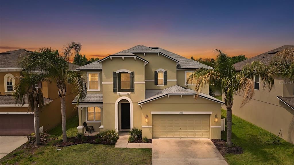 1765 Strathmore Circle Mount Dora, FL 32757 - Photo 1 of 51 a front view of a house with a yard