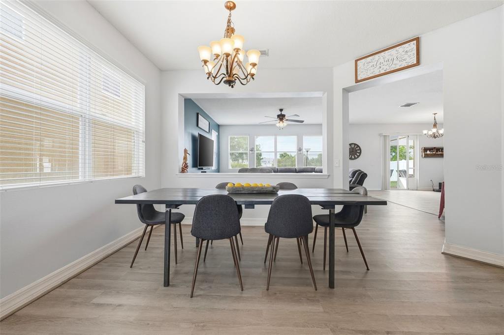1765 Strathmore Circle Mount Dora, FL 32757 - Photo 12 of 51 a view of a dining room with furniture window and wooden floor