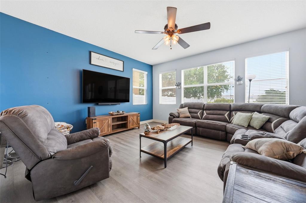 1765 Strathmore Circle Mount Dora, FL 32757 - Photo 13 of 51 a living room with furniture and a flat screen tv
