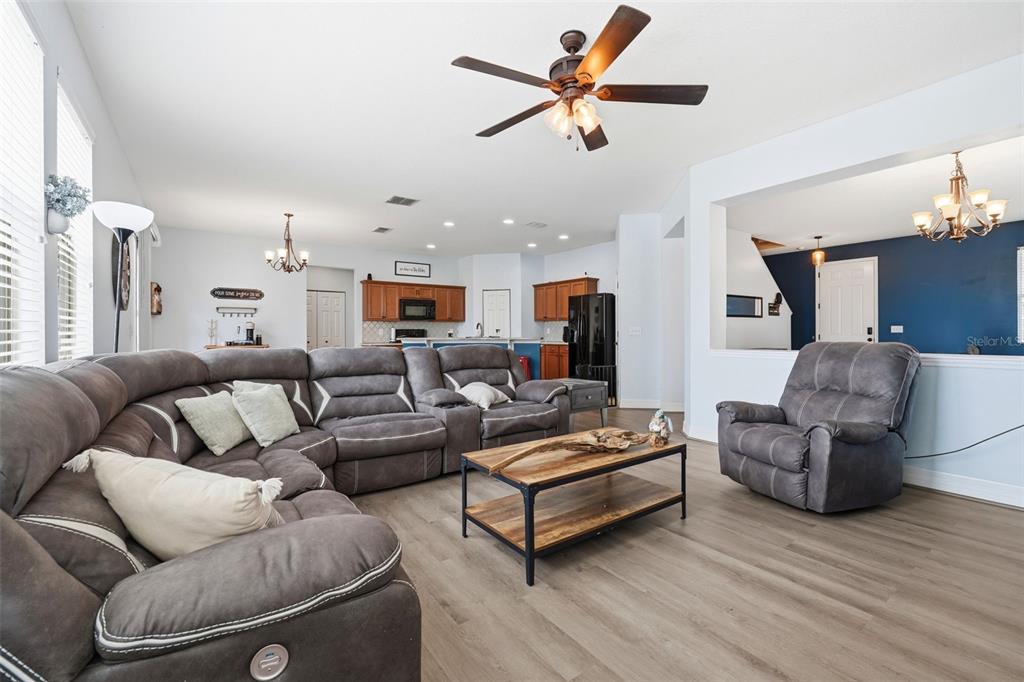 1765 Strathmore Circle Mount Dora, FL 32757 - Photo 15 of 51 a living room with furniture ceiling fan and a wooden floor