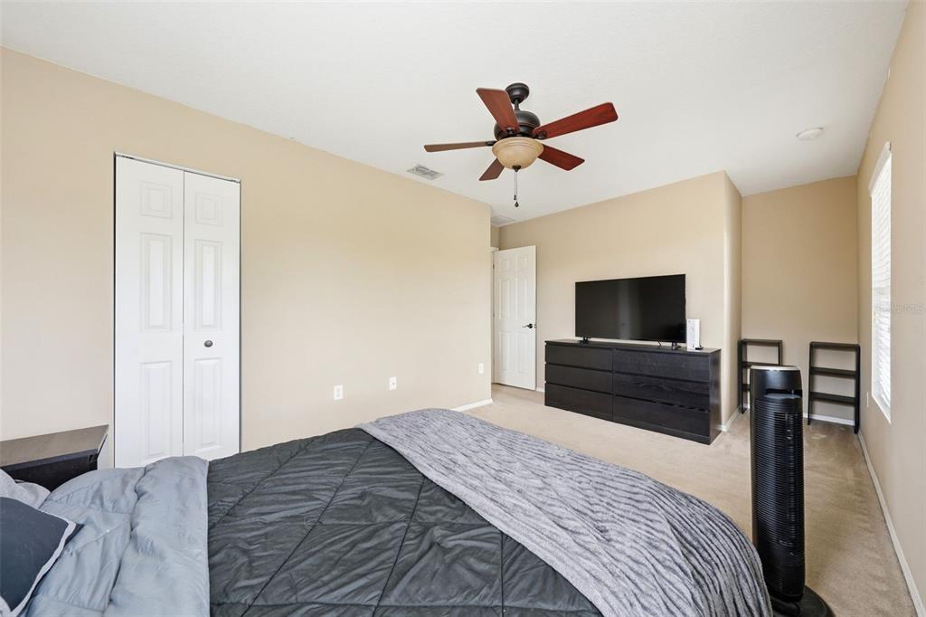 1765 Strathmore Circle Mount Dora, FL 32757 - Photo 17 of 51 a bedroom with a bed and a television