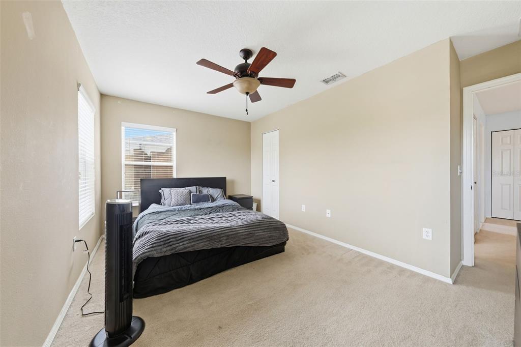 1765 Strathmore Circle Mount Dora, FL 32757 - Photo 18 of 51 a bedroom with a bed and a ceiling fan