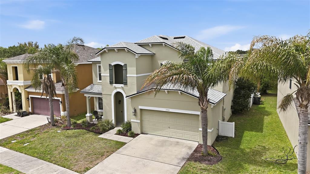 1765 Strathmore Circle Mount Dora, FL 32757 - Photo 2 of 51 front view of a house with a yard