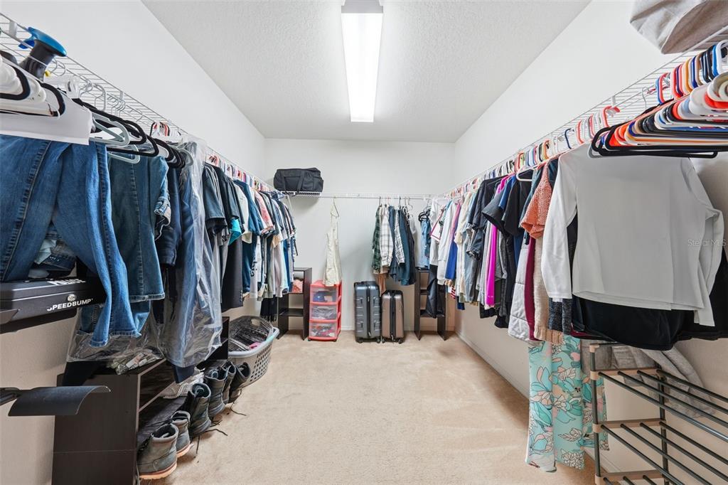 1765 Strathmore Circle Mount Dora, FL 32757 - Photo 23 of 51 a view of walk in closet with clothes