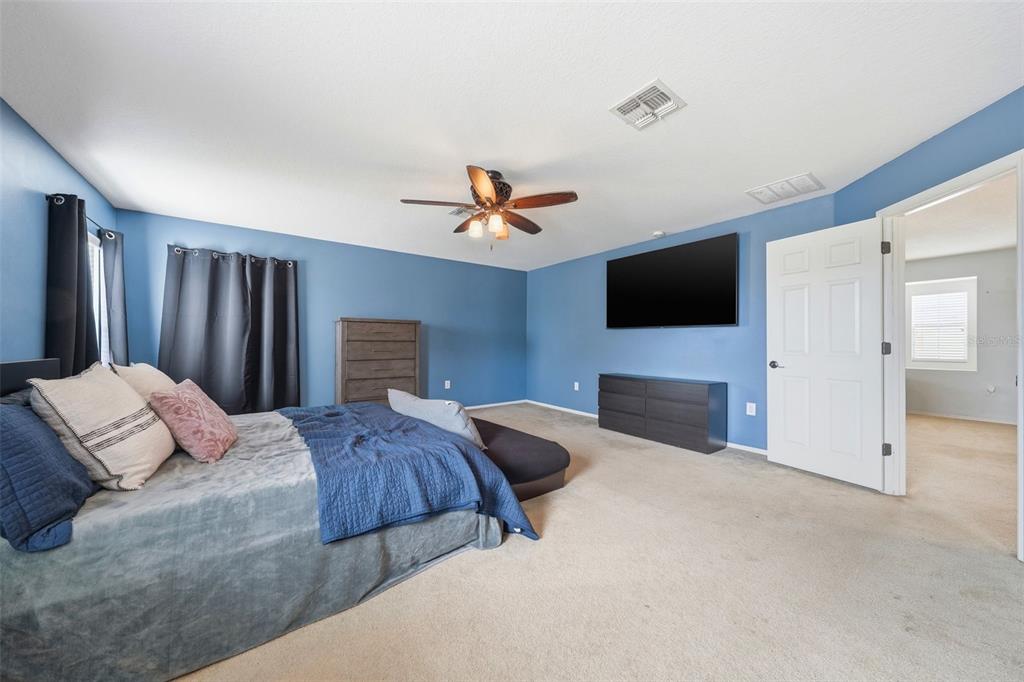 1765 Strathmore Circle Mount Dora, FL 32757 - Photo 24 of 51 a bedroom with a bed and a flat screen tv