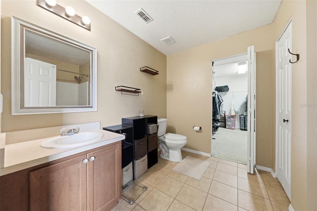 1765 Strathmore Circle Mount Dora, FL 32757 - Photo 26 of 51 a spacious bathroom with a toilet sink and mirror