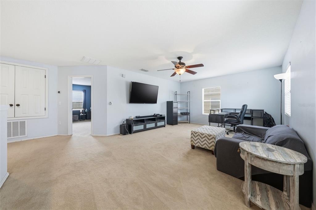 1765 Strathmore Circle Mount Dora, FL 32757 - Photo 28 of 51 a living room with furniture and a flat screen tv