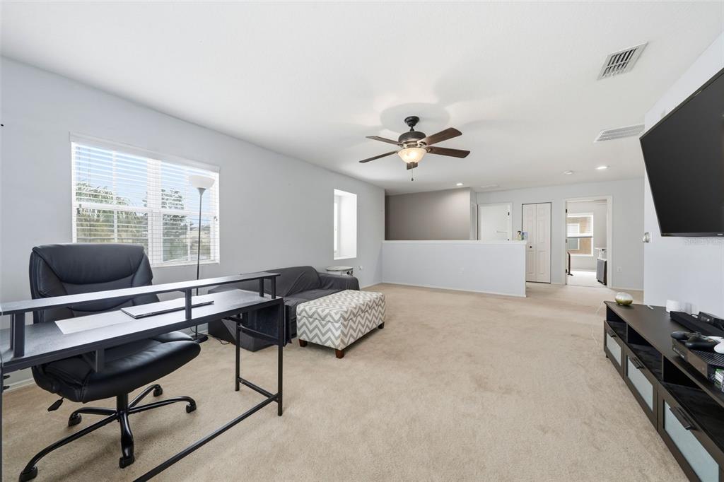 1765 Strathmore Circle Mount Dora, FL 32757 - Photo 29 of 51 a living room with furniture and a flat screen tv