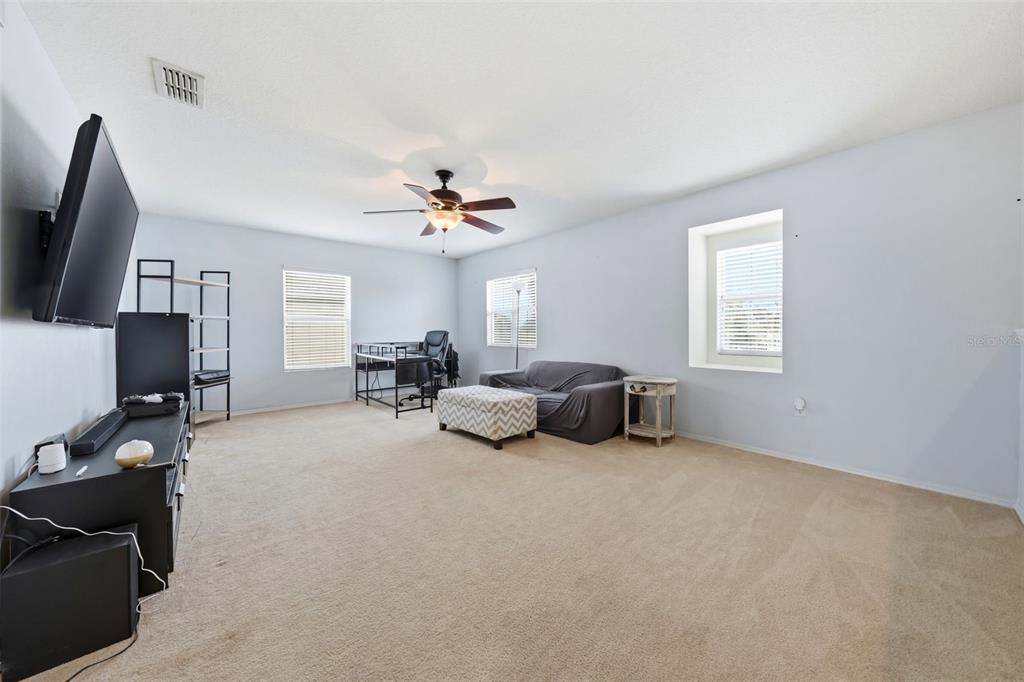 1765 Strathmore Circle Mount Dora, FL 32757 - Photo 30 of 51 a bed room with furniture and a flat screen tv