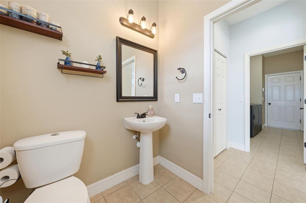 1765 Strathmore Circle Mount Dora, FL 32757 - Photo 32 of 51 a bathroom with a toilet sink and mirror