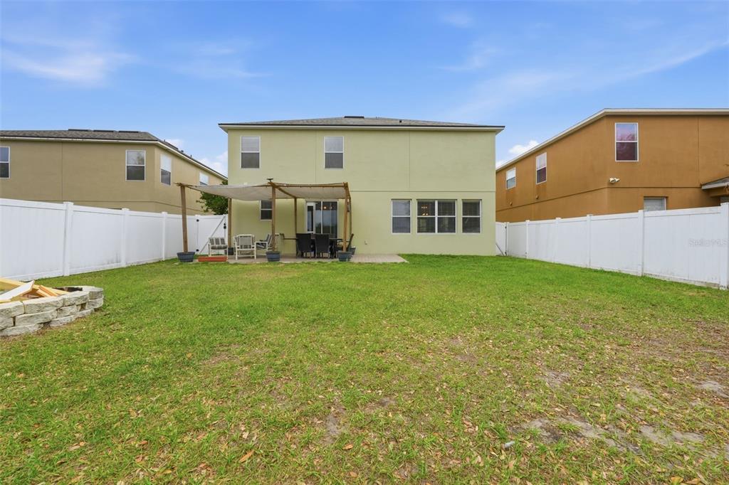1765 Strathmore Circle Mount Dora, FL 32757 - Photo 41 of 51 a view of a house with a big yard and potted plants