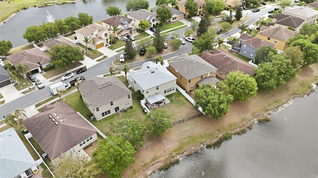 1765 Strathmore Circle Mount Dora, FL 32757 - Photo 47 of 51 an aerial view of a house with a yard and parking