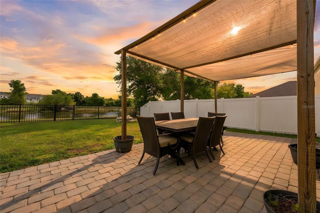1765 Strathmore Circle Mount Dora, FL 32757 - Photo 51 of 51 a view of a patio with a table chairs and a yard