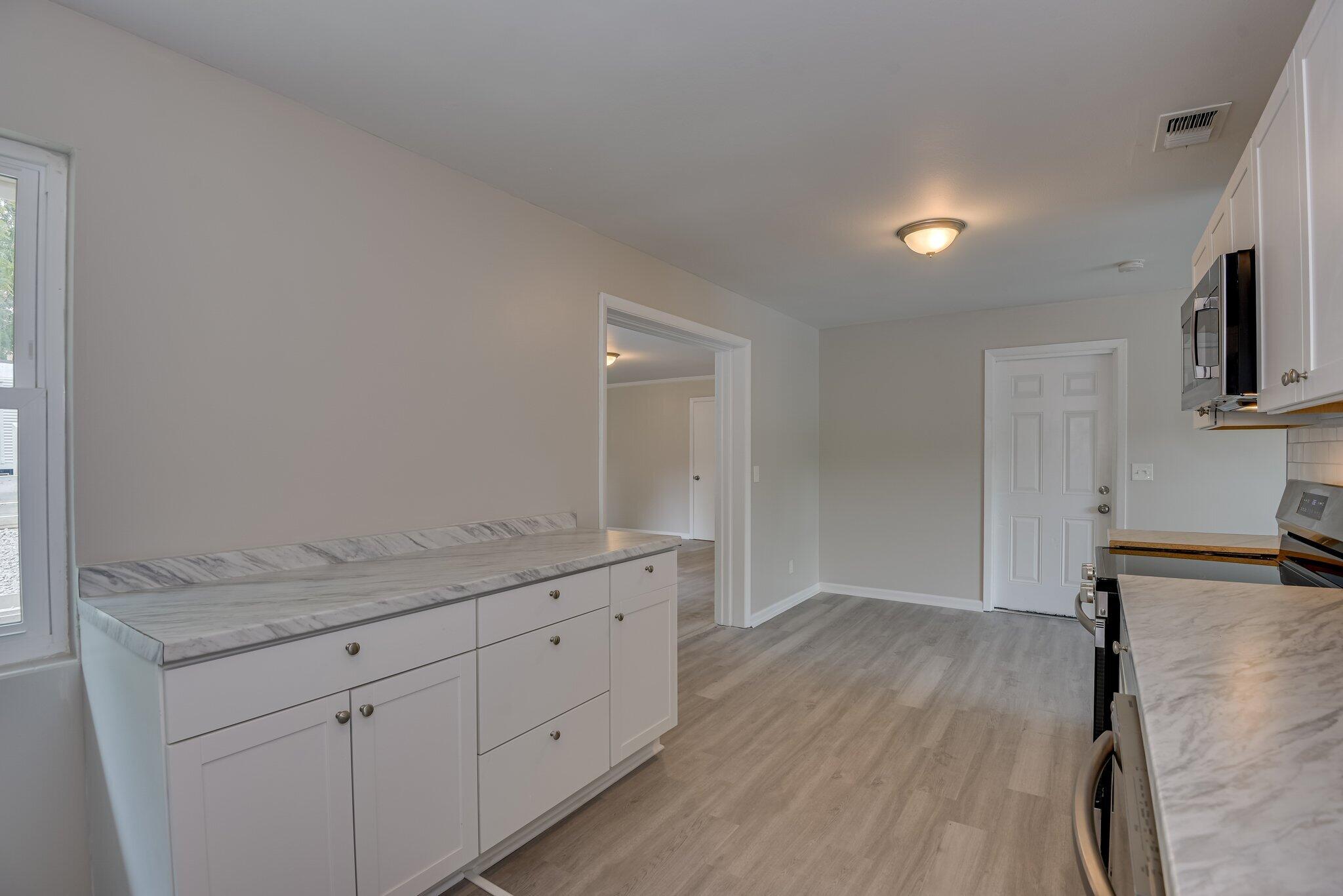2115 Ashley Drive Augusta, GA 30906 - Photo 16 of 38 a hallway with sink and wooden floor