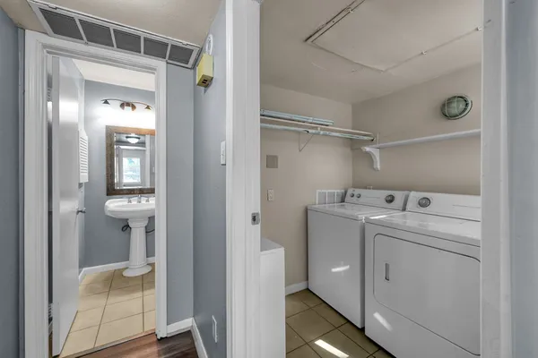 a utility room with closet dryer and washer