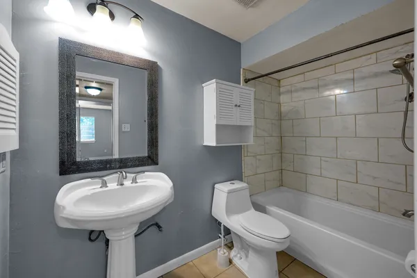 a bathroom with a sink a toilet and bathtub