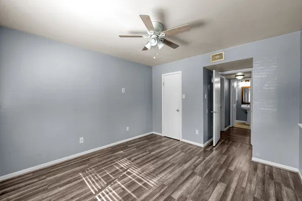 a view of a room with wooden floor