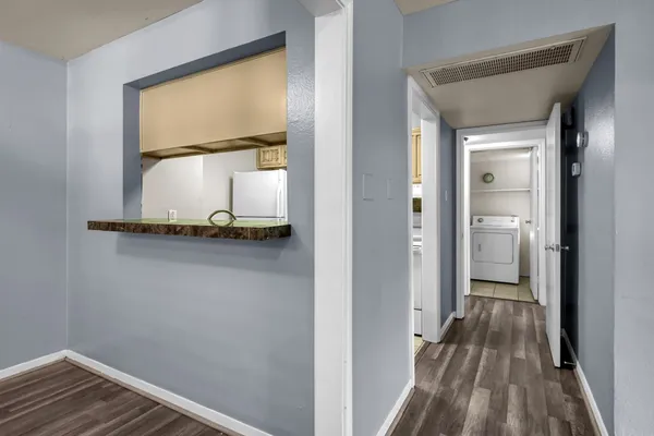 a view of an entryway with wooden floor