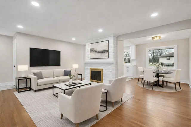 an empty room with wooden floor and window