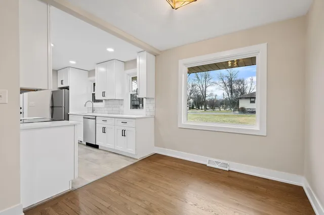 a kitchen with stainless steel appliances white cabinets and stove