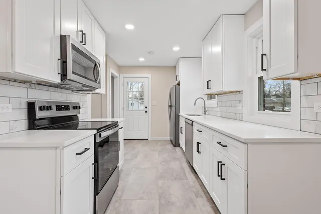 a kitchen with stainless steel appliances granite countertop a stove and a refrigerator