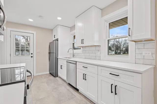 a kitchen with sink cabinets and window