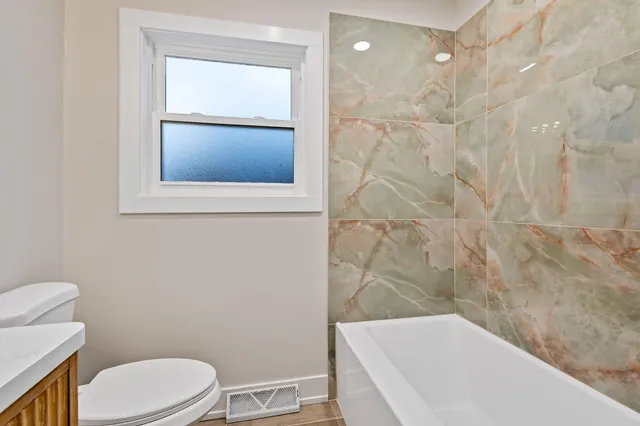 a view of an empty room and wooden floor