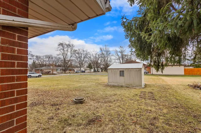 an empty room with wooden floor and fireplace
