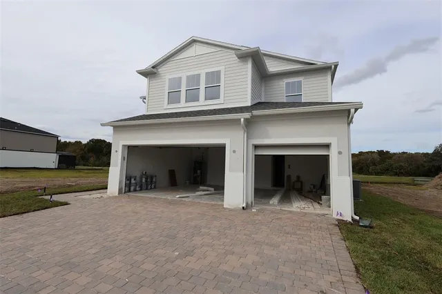 a view of a house with a yard and garage
