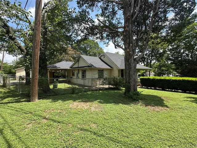 a front view of house with yard and green space