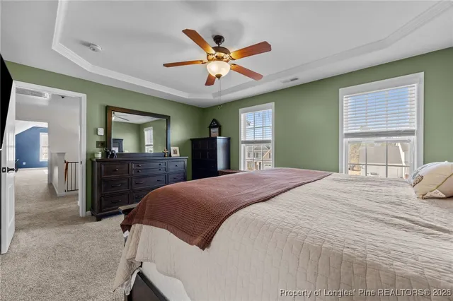 a bedroom with a large bed and a large mirror