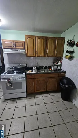 a kitchen with a stove a sink and a cabinets