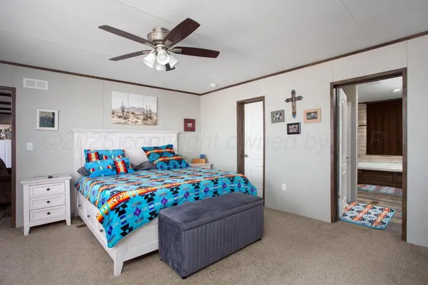 a bedroom with a bed and a chandelier