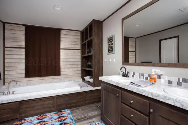 a bathroom with a sink double vanity granite and a mirror