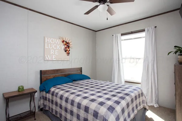 a bedroom with a bed and a desk