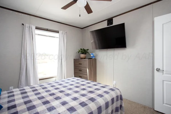 a bedroom with a bed and a flat screen tv