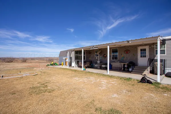 a view of a house with outdoor space and sitting area