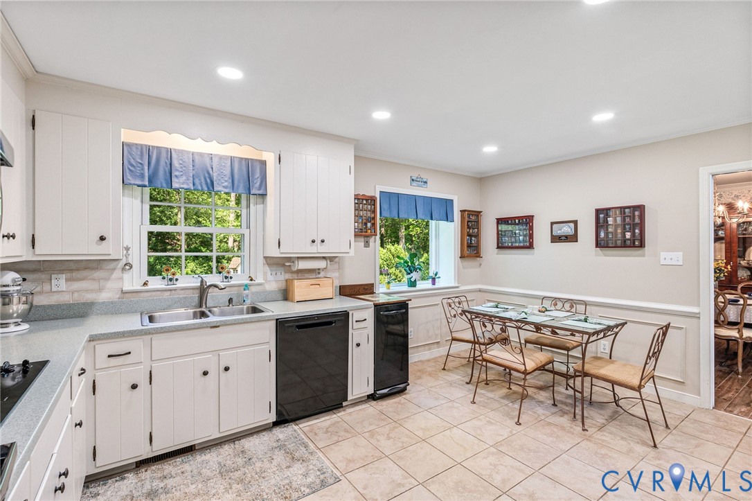 5700 Elfinwood Road Chester, VA 23831 - Photo 14 of 38 a kitchen with a sink dining table and chairs