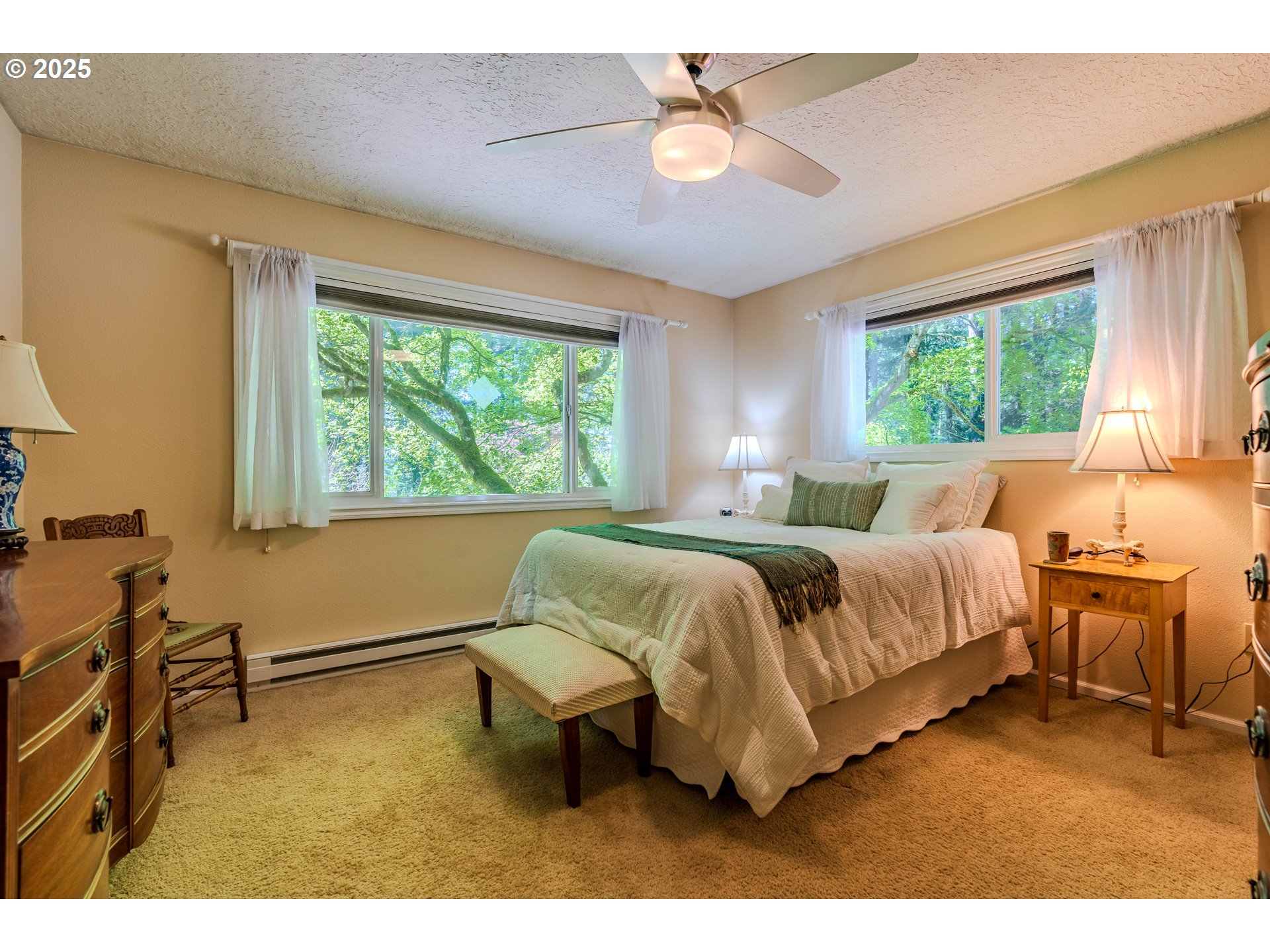 41920 Southeast Gordon Creek Road Corbett, OR 97019 - Photo 12 of 48 a spacious bedroom with a bed and a table in it