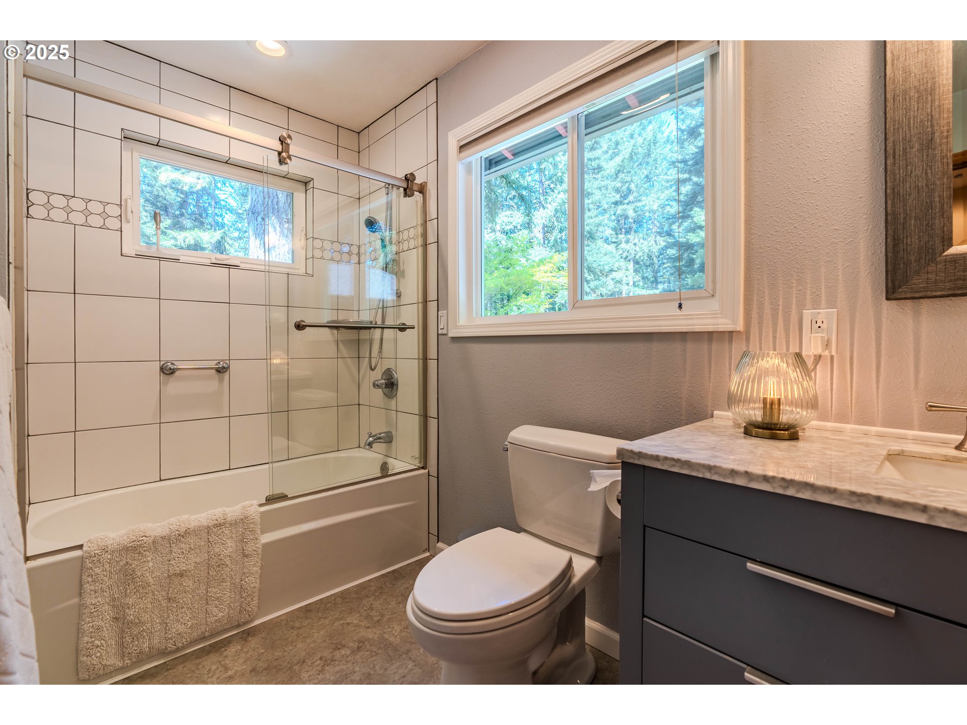 41920 Southeast Gordon Creek Road Corbett, OR 97019 - Photo 18 of 48 a bathroom with a granite countertop sink toilet a mirror and shower